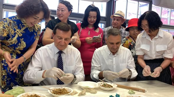 Lunar New Year dumpling making at Burwood — community members folding dumplings together