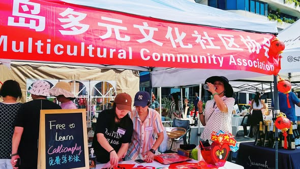Community member holding a traditional Chinese 福 calligraphy artwork